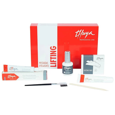 A complete eyelash lifting kit displayed, including a red and white Thuya branded box, tubes, bottles, silicone pads, a brush, and a wooden stick.