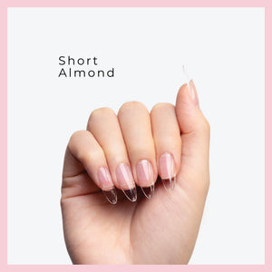 Curacoro short Almond Soft Gel Nail Tips on a hand, featuring natural nails with clear extensions, set against a light gray background with a pink border.