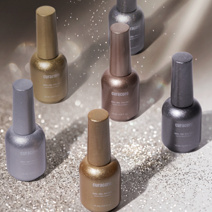 Collection of Curacure nail polish bottles on a reflective surface with a gradient background.