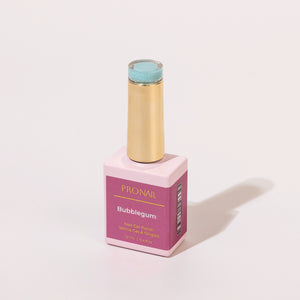A Bubblegum nail polish bottle with a gold cap casting a shadow on a white background.