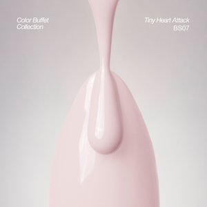 A glossy light pink product with a teardrop-shaped top and smooth curved body, shown against a soft light gray background. White text in the corners reads &