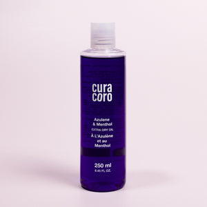 Azulene & Menthol Extra Dry Oil Bottle Over Light Background