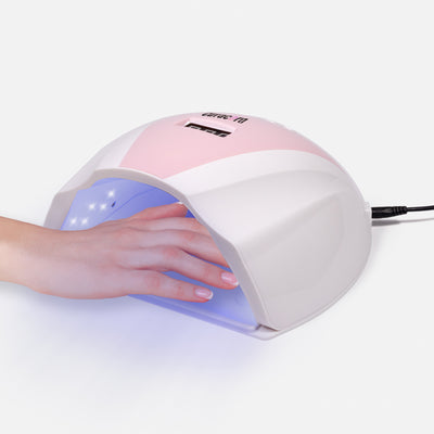 Professional 108W UV LED Nail Lamp with hand model over white background