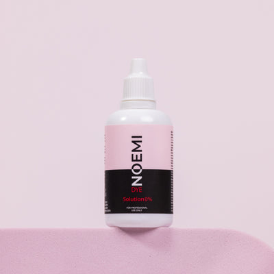 Noemi Developer Corrector 0% Bottle Over Pink Background