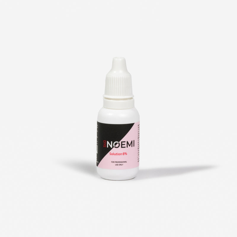 Noemi Solution 6% Bottle Over White Background