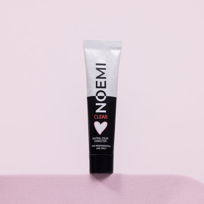 Noemi Neutral Color Corrector Bottle Over Pink Background