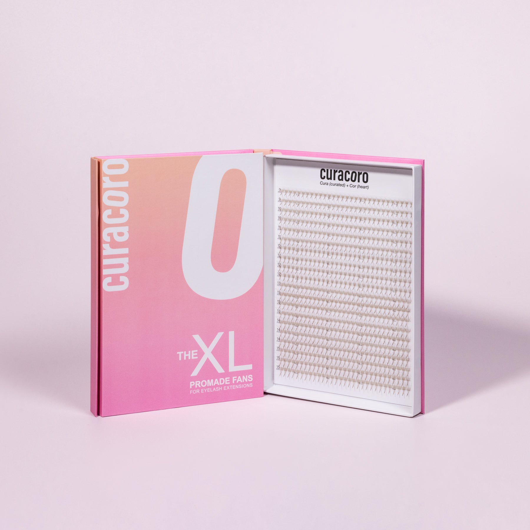 An open pink and white box labeled "The XL Promade Fans," displaying neatly arranged lash fans on a white background.