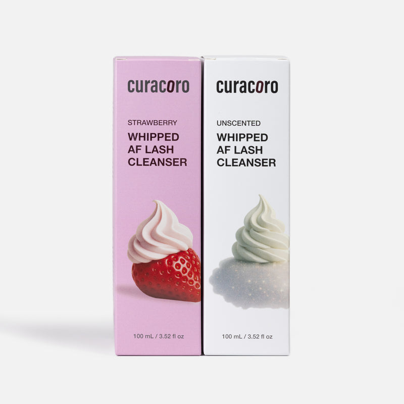 Two boxes of curacoro lash cleanser, one strawberry-flavored and one unscented, on a white background.