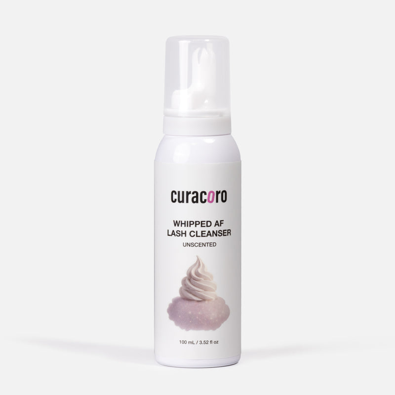 White bottle of curacoro whipped AF lash cleanser on a white background