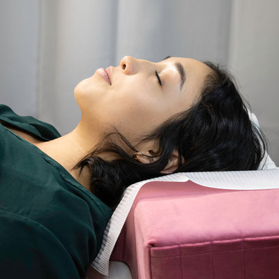 Client laying on the Pink Memory Foam Pillow.