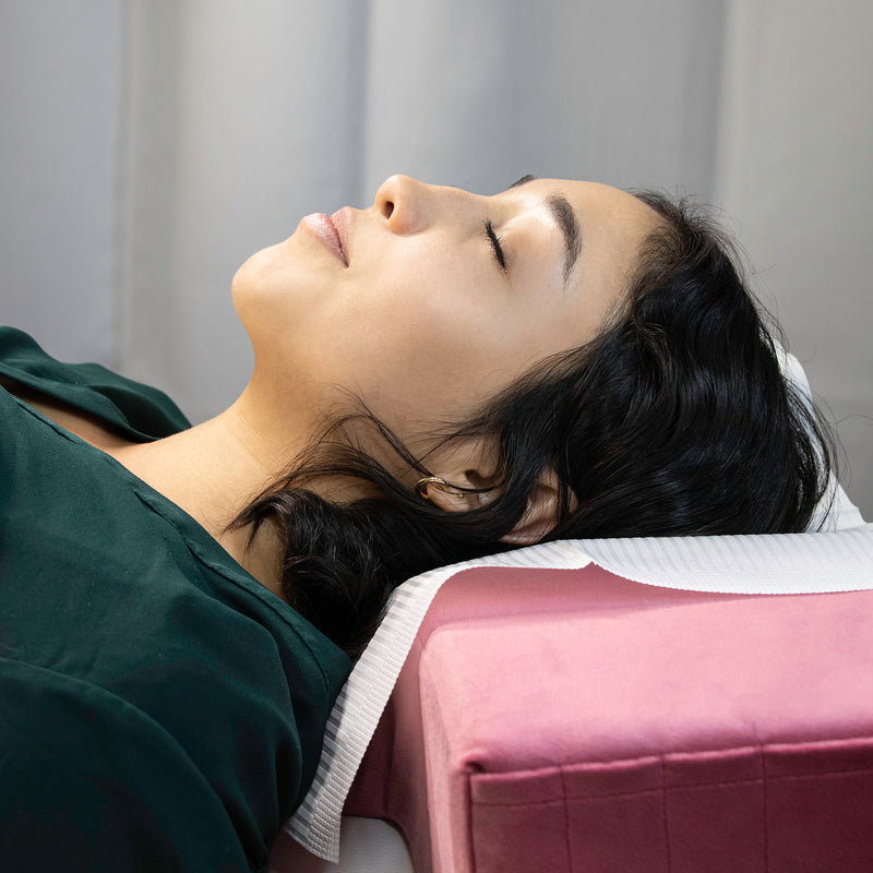 Client laying on the Pink Memory Foam Pillow.