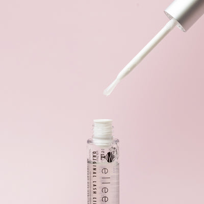 Lash lift adhesive tube with the lid and integrated brush displayed 