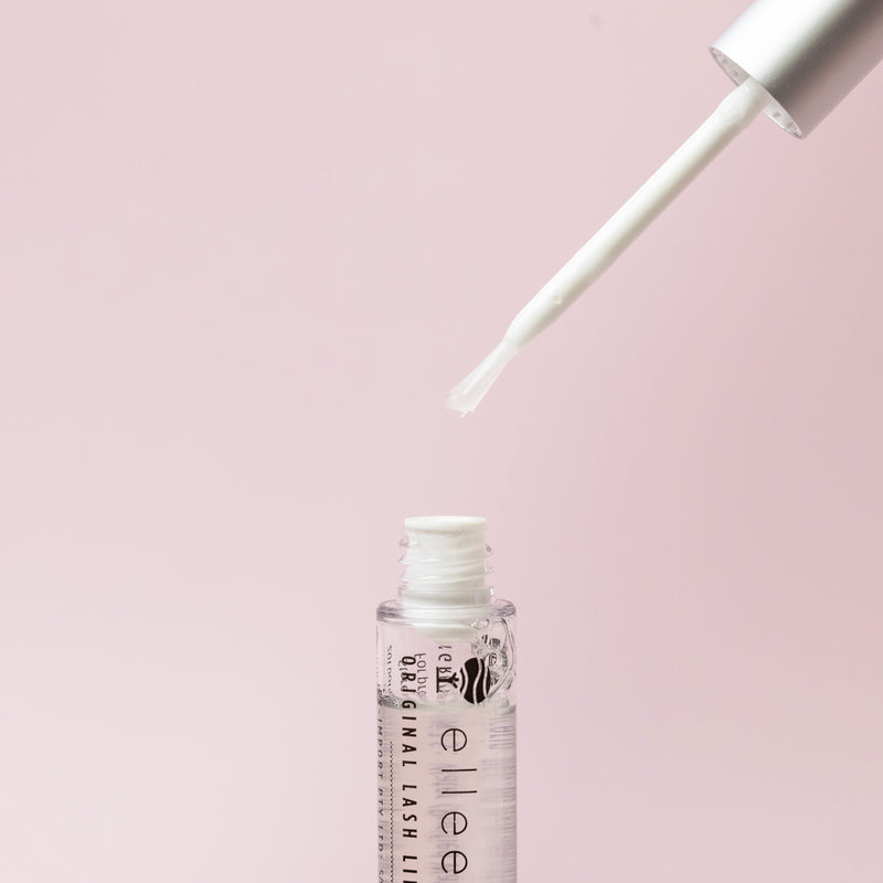 Lash lift adhesive tube with the lid and integrated brush displayed 