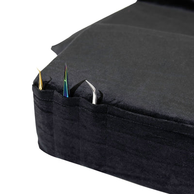 Pockets of the Black Memory Foam Pillow holding lash extension tweezers.