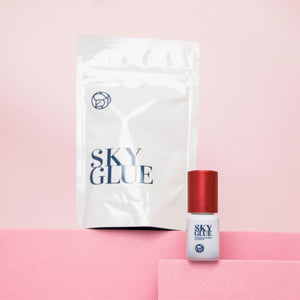 Sky Glue bottle for lash extensions with white packaging in the background