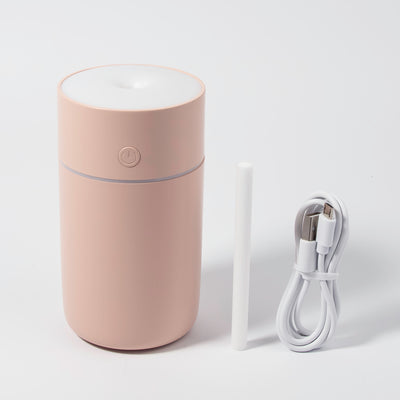 Image of the humidifier with its charger in a white background. 