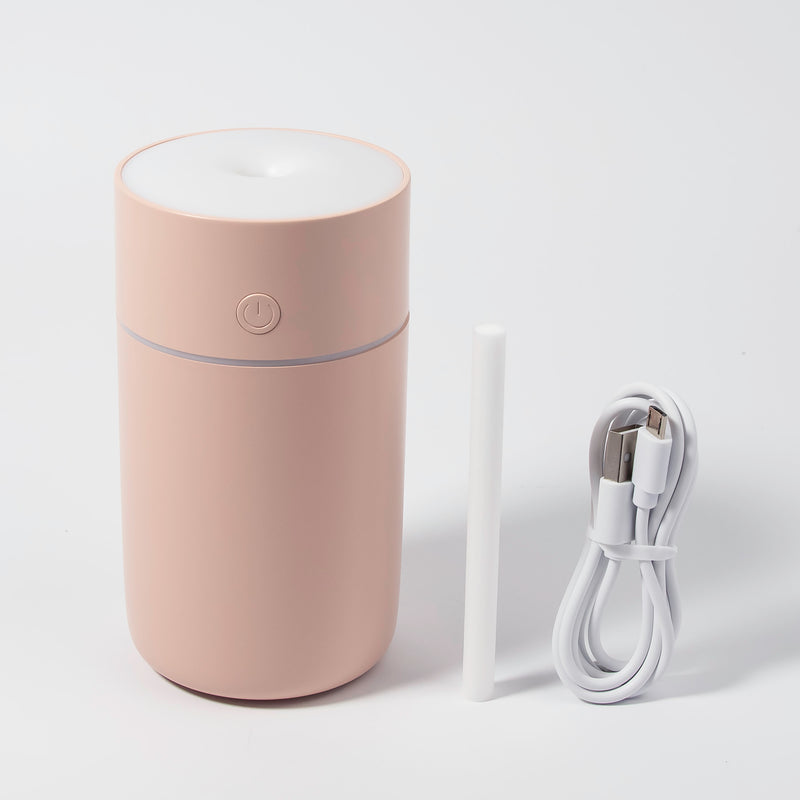 Image of the humidifier with its charger in a white background. 