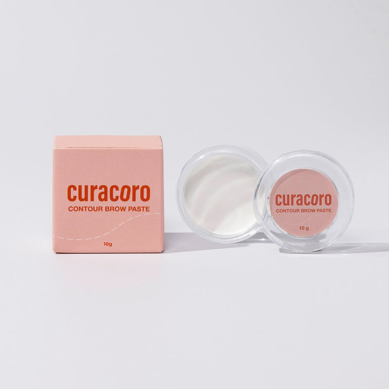 Image of our Contour Brow Paste and case box standing in front of a pink background.