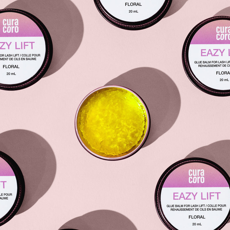 Curacoro Eazy Lift Glue Balm Displayed Over Pink Background