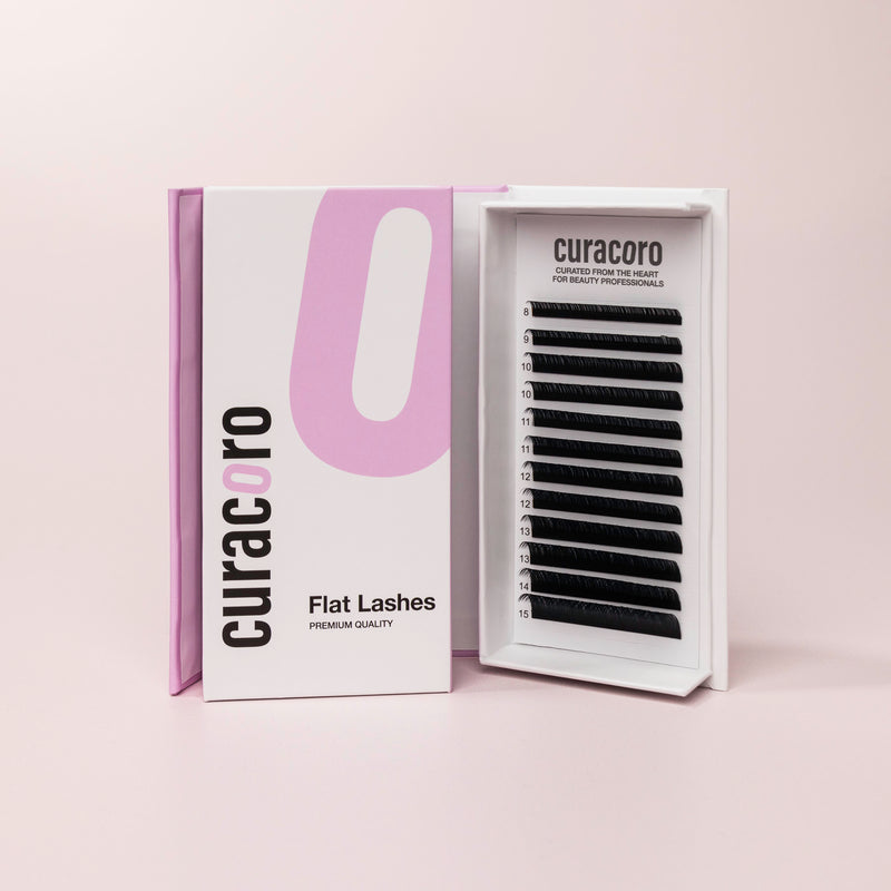 Flat Lashes in front of a pink background with an open case.