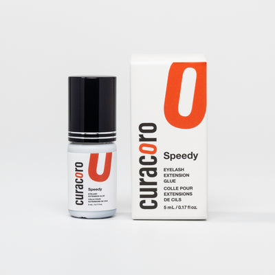 Curacoro Speedy Eyelash Extension Glue, 5 mL, in a white bottle with a black cap, designed for professional lash applications.