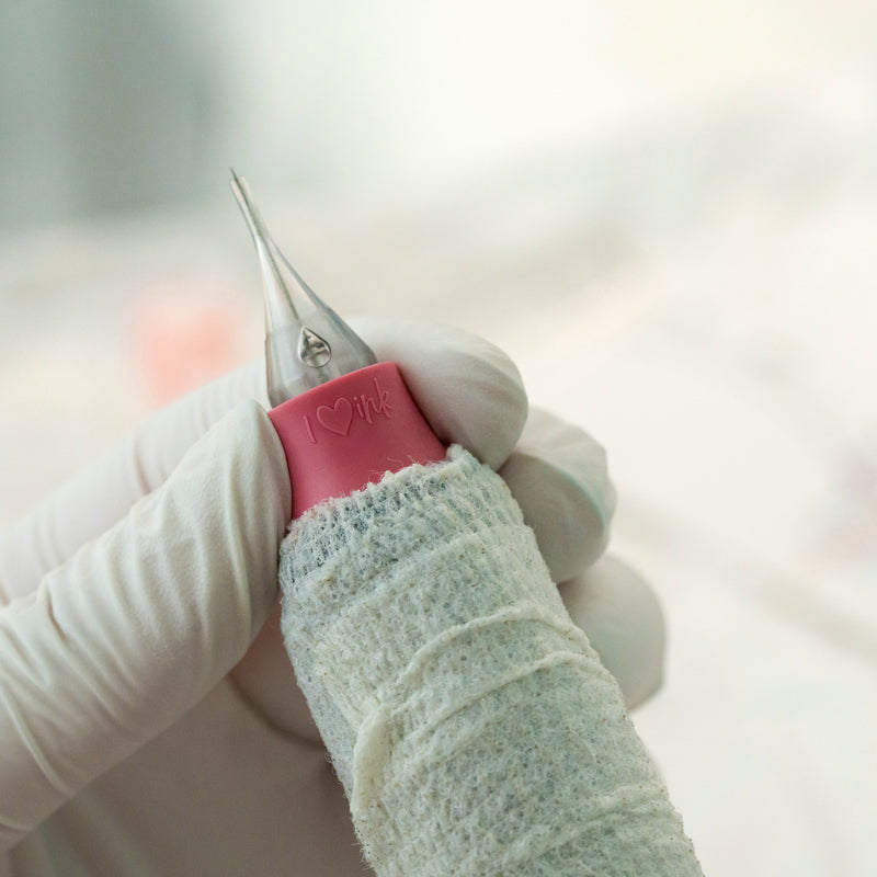 Needle cartridges held in hand, displayed