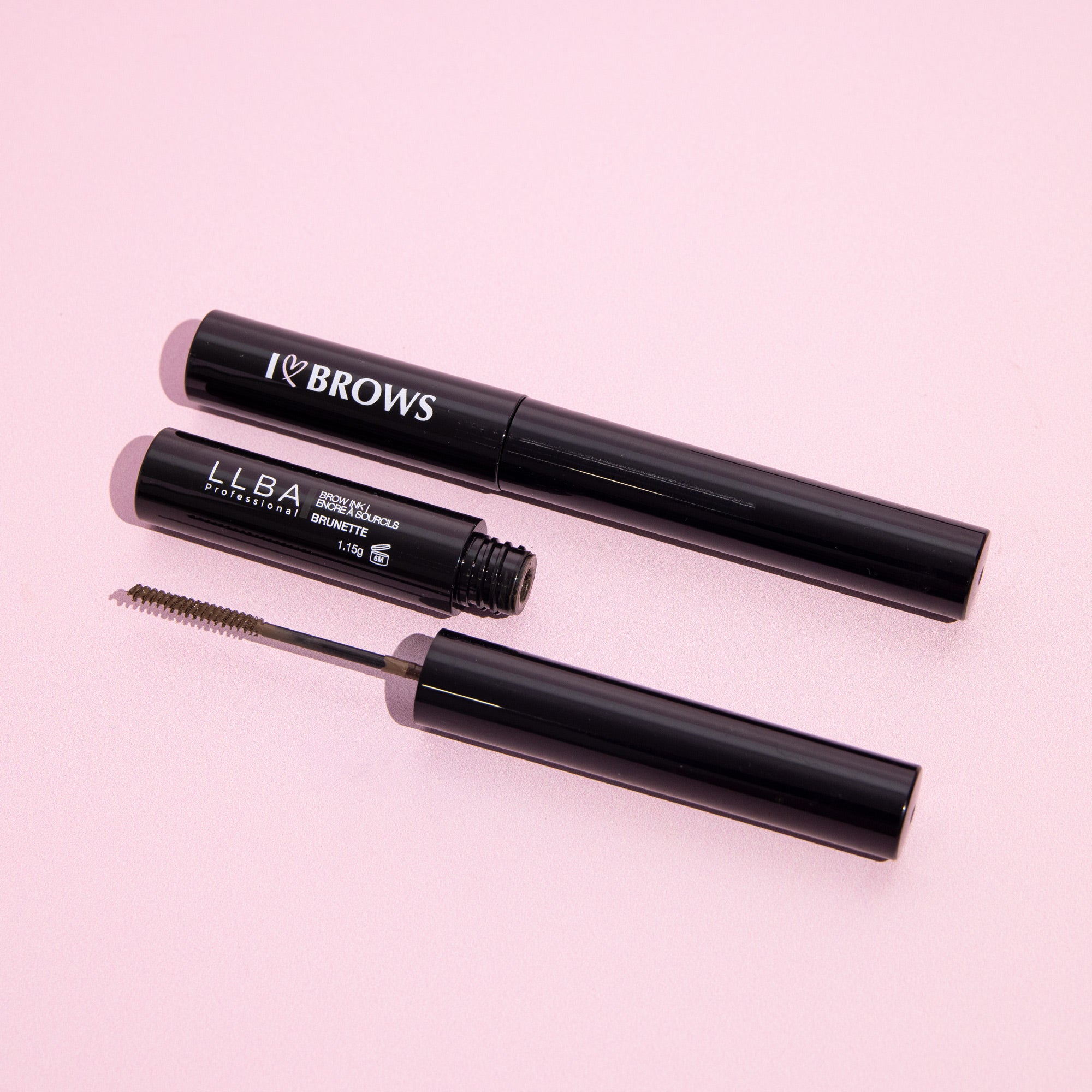I ❤️  Brows Brow Gel Ink - Invisible with brush applicator, displayed on a pink background.